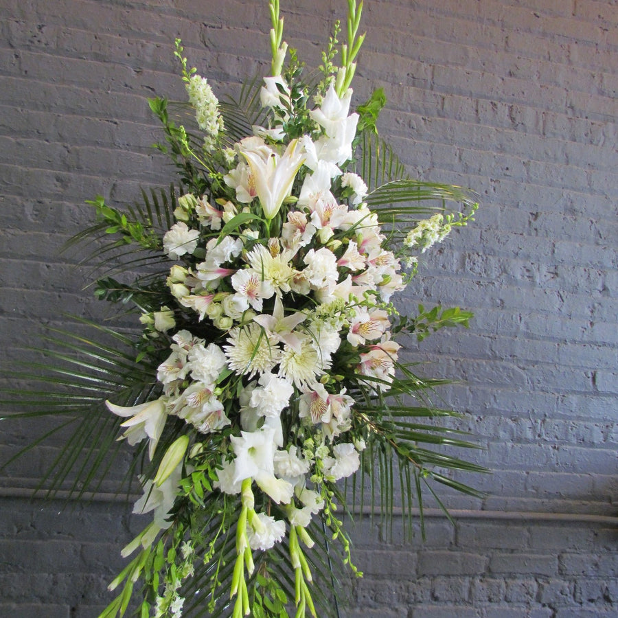Funeral tribute spray in all white flowers