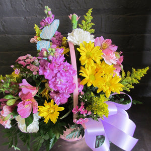 Spring basket arrangement with bow and butterfly. 