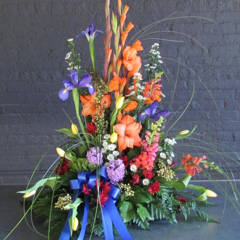 Beautiful tall and bright traditional funeral arrangement