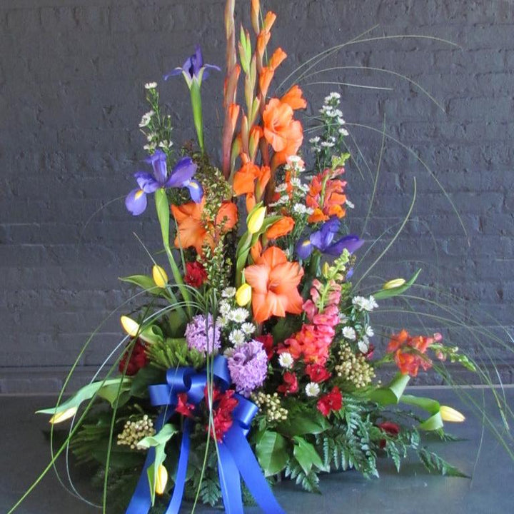 Beautiful tall and bright traditional funeral arrangement